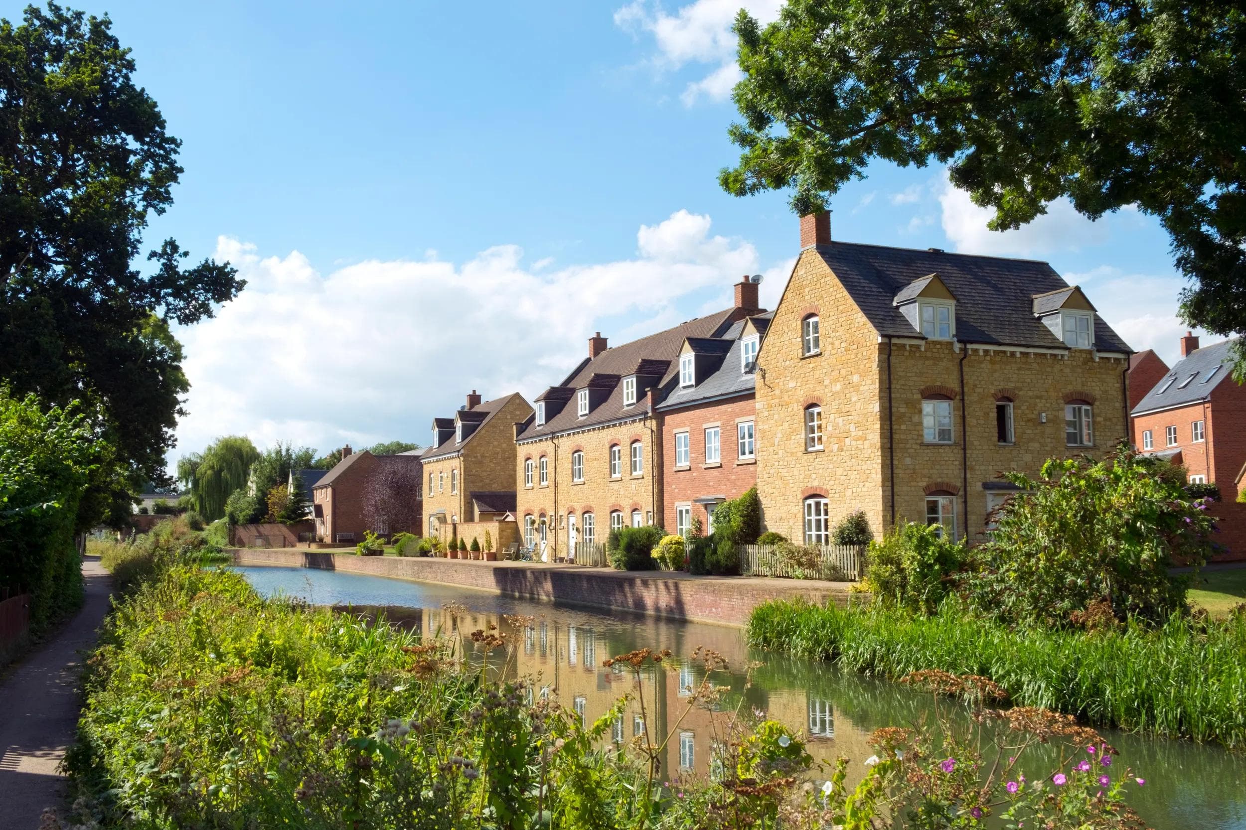 Recently built housing enhances the historic canal near Ebley Mill on the restored Stroudwater Canal, Stroud, Gloucestershire, UK.